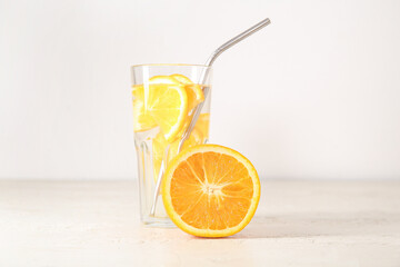 Glass of infused water with orange on white background