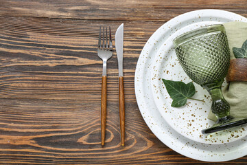 Stylish modern table setting on brown wooden background