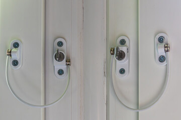 Bolted locks on the windows for the safe stay of children in the house