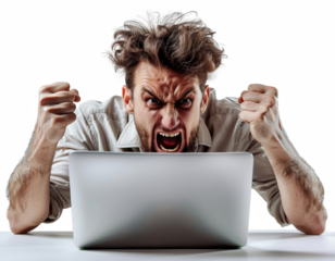 A man is sitting at a desk with a laptop in front of him