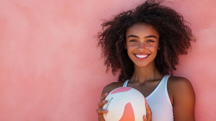 Radiant Young Woman with Volleyball in Sunlight against Coral Background