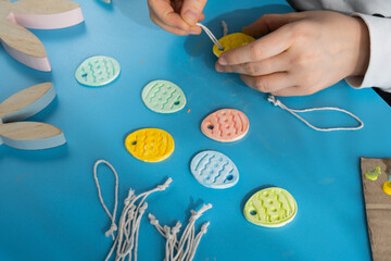 Creator is using white air dry clay for making decor to EASTER holiday. Creating hobby recreation activity that involves fingers. DIY crafting Modern art 