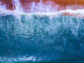 Top view waves crashing on sandy shore, Beach sea space nature background