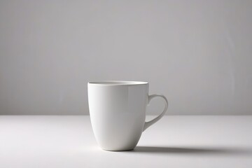 Obraz premium a white cup sitting on top of a table 