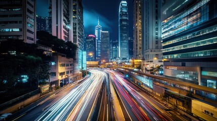Fototapeta premium Night cityscape with a highway and light trails.