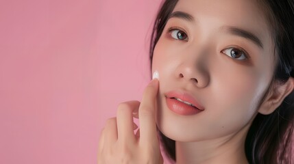 Fototapeta premium Radiant Asian Woman Applying Facial Cream – Perfect for Skincare, Beauty Treatments, Facial Care, and Self-Care Illustrations Showcasing Luxurious and Effective Beauty Routines