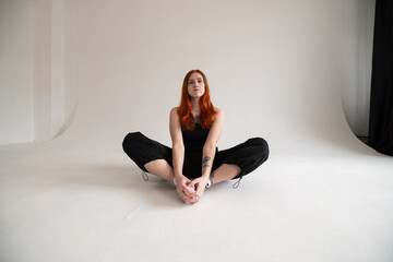 Obraz premium Portrait of a beautiful young red-haired girl in a studio.