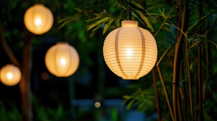 Obraz premium Elegant paper lanterns glow softly in a serene outdoor setting, surrounded by lush greenery, creating a tranquil ambiance.