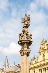 Fototapeta premium The top of the fountain with plague column is located in public park on Charles Square in old part of Prague in Czech Republic