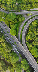traffic on the highway passing through greenery, aerial view
