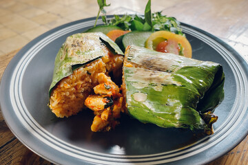 Indonesian food Nasi bakar ayam kemangi or grilled rice with basil chicken