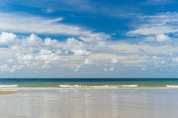 seascape landscape background by sea sand beach or island with little waves and nature white clouds on blue sky daylight for summer holiday travel at rayong in thailand and take photo with cpl filter