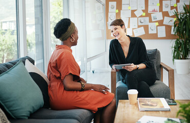 Businesswomen, meeting and collaboration with tablet on sofa for creative project ideas and brainstorming. Professional, happy employees and laughing for funny design strategy, workflow and feedback