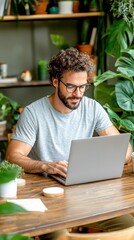 Man Working on Laptop in a Green and Relaxing Home Office
