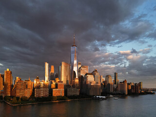 Fototapeta premium New York City top view. NYC aerial view, New York City Skyline with dramatic sky. Panoramic drone view on Manhattan in NY. Night in NYC. New York City Midtown skyline view at dusk with clouds.