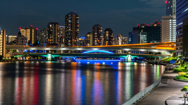 A night of the neon street at the downtown in Tokyo with the Sumida river. Night shot with long exposure. Wide shot.
