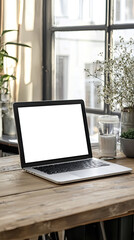 A modern laptop with blank screen sits on wooden table, surrounded by plants and decorative items, creating serene workspace atmosphere