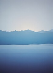 Fototapeta premium A serene landscape with a calm body of water and distant mountains, captured in a minimalist style with a gradient of blue and gray tones.