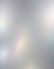 The image is a blurred, abstract representation of a cloudy sky, with a gradient of gray and white colors.