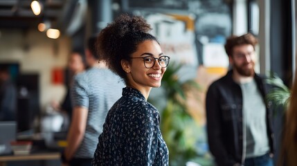 Fototapeta premium Smiling Woman in Glasses Turning Her Head, Blured Office Background
