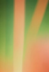 Obraz premium The image is a blurred, abstract representation of a rainbow, with vibrant colors of green, orange, and yellow.