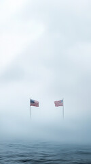 Fototapeta premium image features two American flags standing tall amidst foggy and misty atmosphere, creating serene yet powerful visual. flags symbolize unity and strength, contrasting beautifully with soft, muted ba