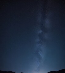 The Milky Way galaxy stretches across the night sky, its spiral arms visible against the dark backdrop.