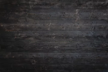  Rustic, dark wood surface aged texture showcases intricate grain patterns. Charred and weathered, planks reveal vintage, earthy warmth, creating natural, organic feel reminiscent of firewood. © Phushutter