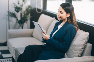 Business woman working from home. work online on laptop. Asian businesswoman working on sofa online business with social distancing laptop online meeting