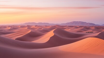 Naklejka premium rolling sand dunes , with a caravan of camels moving across the distant horizon, the sky painted with soft pinks and oranges at sunset