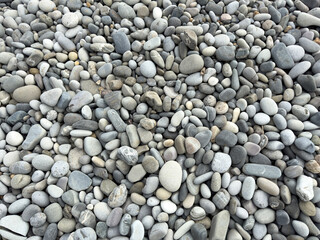 Stone pebbles as an abstract background. Texture