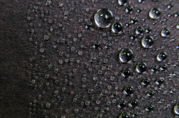 Closeup of water droplets on dark cover background. Water droplets and wallpaper concept