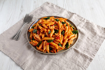 Homemade One-Pot Spinach And Tomato Pasta on a Plate, side view.