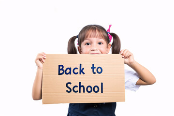 Little child holding a cardboard sign bearing the words "Back to School" against a clean, white background.
