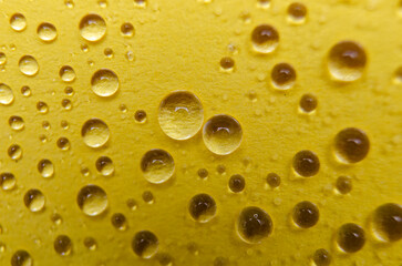 Close up of water droplets on yellow cover background. Water droplets and wallpaper concept