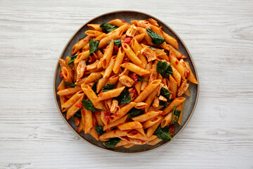 Homemade One-Pot Spinach And Tomato Pasta on a Plate, top view. Flat lay, overhead, from above.