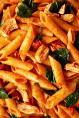 Homemade One-Pot Spinach And Tomato Pasta on a Plate, top view. Close-up.