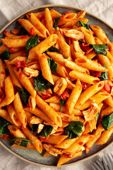 Homemade One-Pot Spinach And Tomato Pasta on a Plate, top view. Close-up.