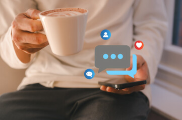 Man using smartphone and holding coffee cup checking social media sitting in cafe in concept of business and social network lifestyles