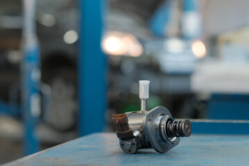 Auto parts. The new high-pressure fuel pump is on the car mechanic's desk.