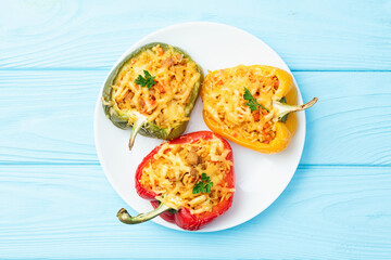 Baked stuffed pepper ( paprika ) with rice , carrot and meat . Top view on rustic background