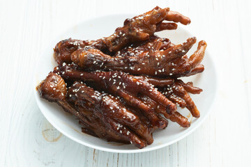 Caramelized korean or Chinese chicken foots ( paws ) with sesame . Top view