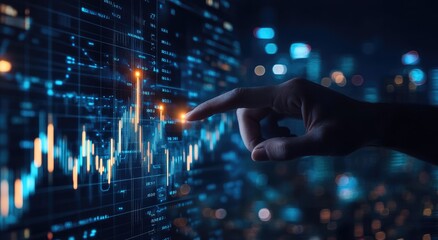 Hand pointing at rising stock market data on a computer screen.