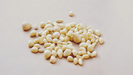 Garlic Cloves Peeled Close-Up White And Beige Background Organic