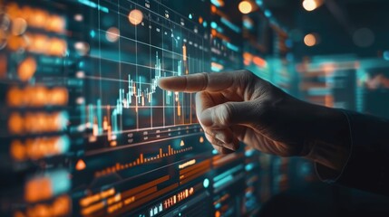 Fototapeta premium A hand points at a stock market graph on a computer screen, showing growth and profitability.
