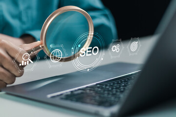 Businessman using laptop with SEO icon to analyze SEO search engine optimization for promoting...