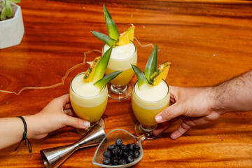 Refreshing cocktails of piñacolada on a wooden table. Copy space. Black friday.