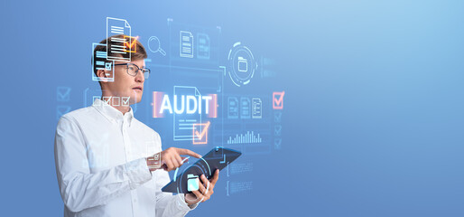 Man in white shirt using a tablet with digital audit graphics ov
