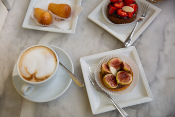 Cup of coffee and sweet fresh figsle table.
