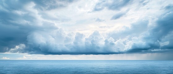 A serene seascape featuring calm waters and a dramatic sky filled with wispy clouds and varying shades of blue.